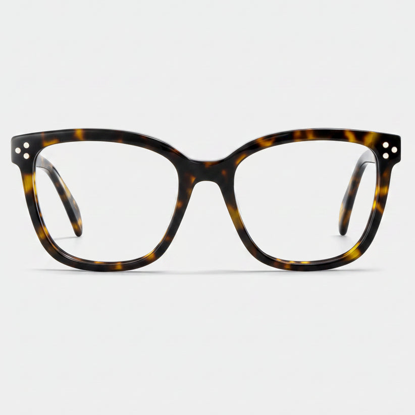 Tortoiseshell eyeglasses on a light gray background