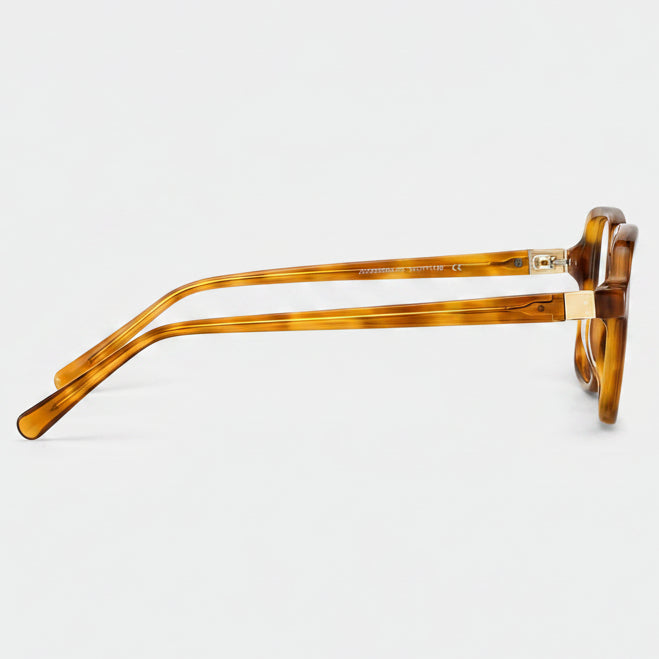 Brown tortoiseshell eyeglasses on a light gray background