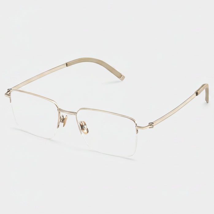 Gold-rimmed eyeglasses on a light gray background