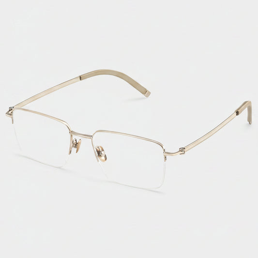 Gold-rimmed eyeglasses on a light gray background