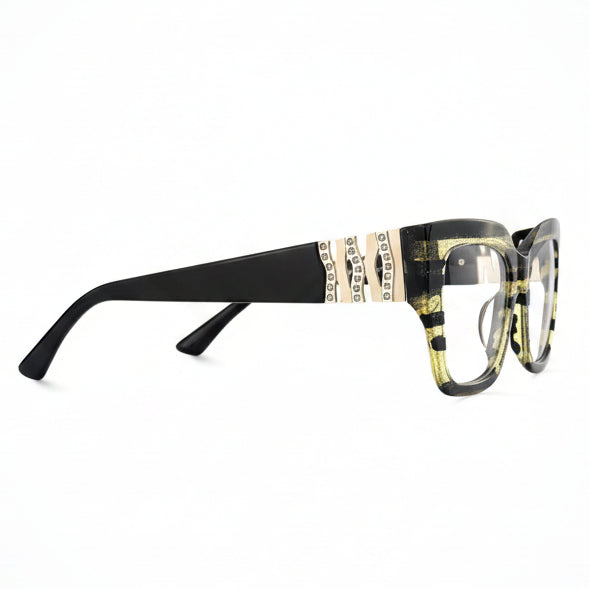 Decorative eyeglasses with black frames and gold accents on a white background