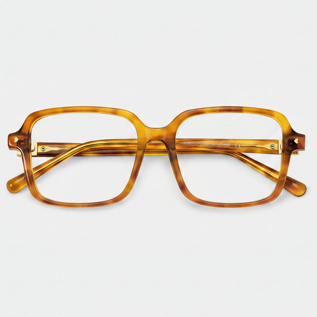Tortoiseshell eyeglasses on a light gray background