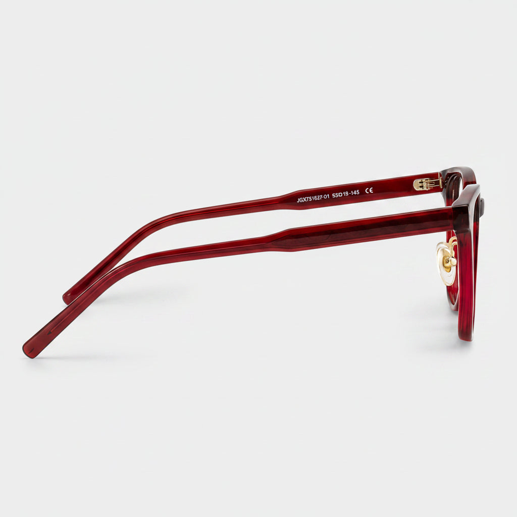 Red sunglasses with gold accents on a white background
